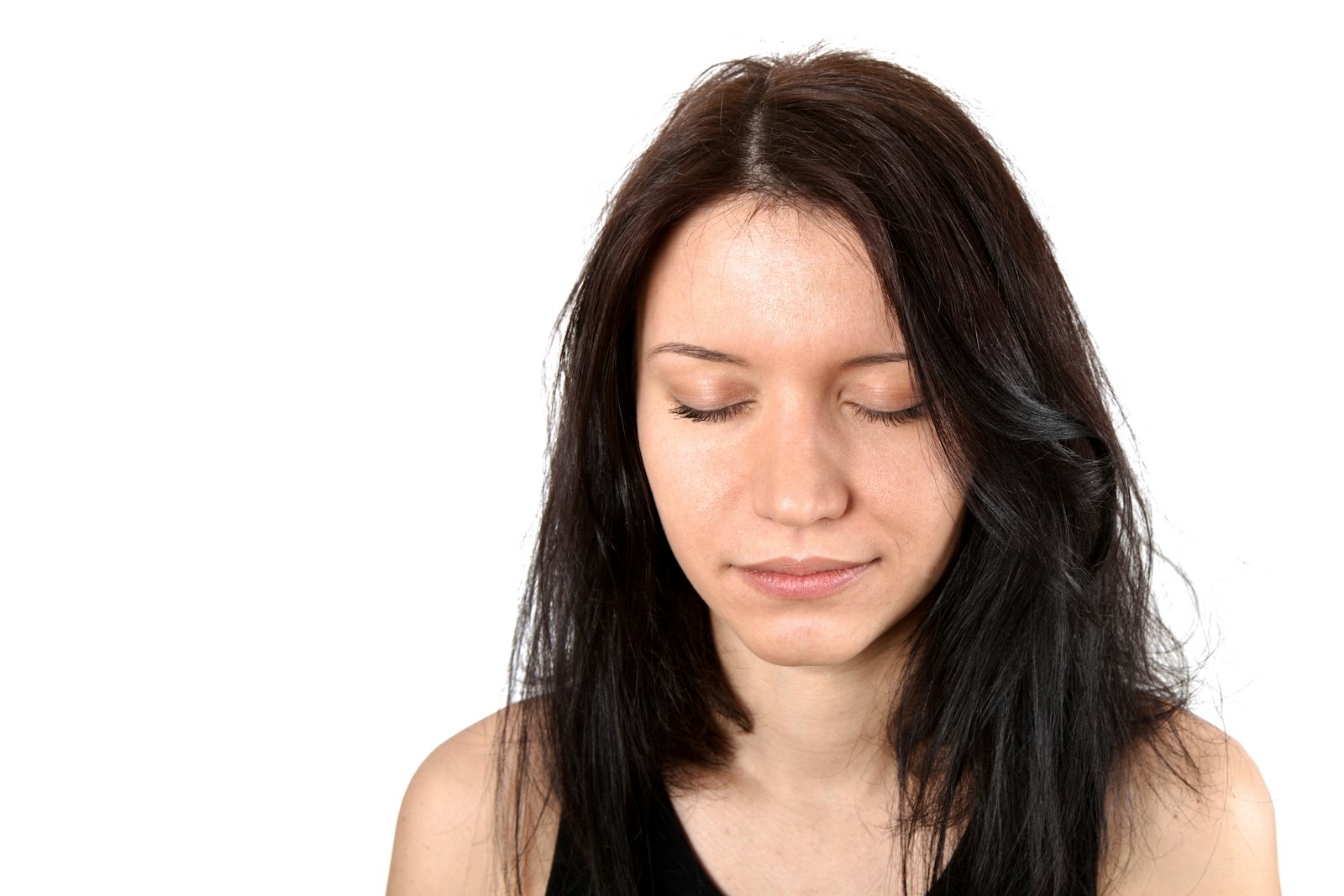 Woman looking down at a phone screen in low light