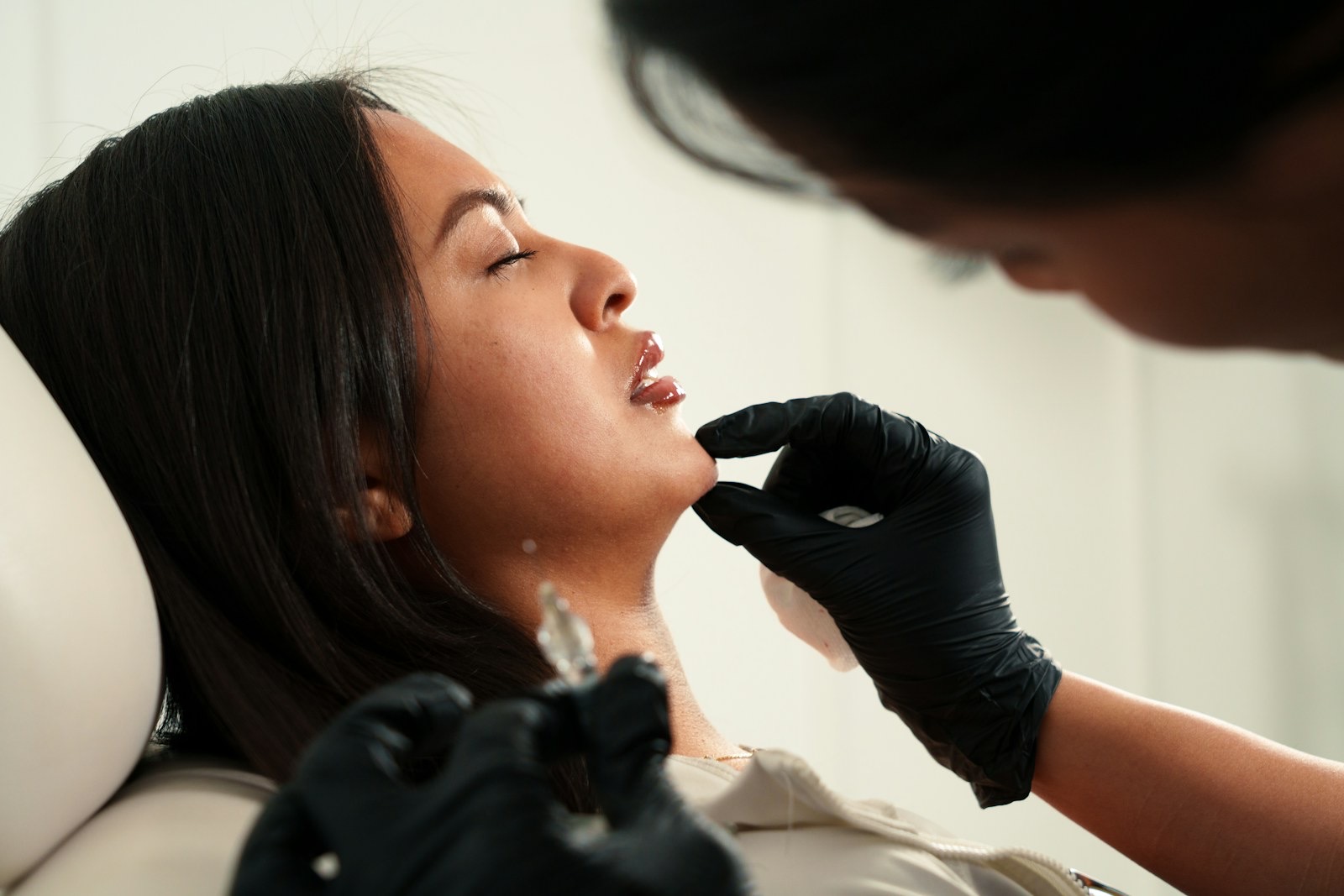 A woman receiving a cosmetic injection on her chin